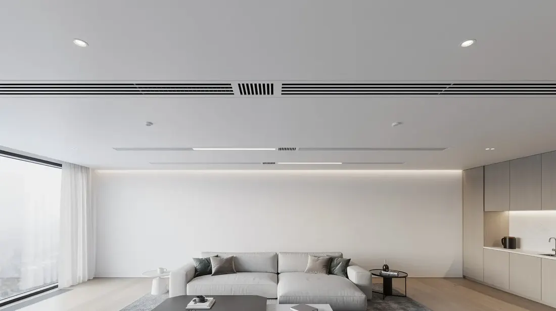 L'image montre des bouches de ventilation discrètes intégrées au plafond d'un intérieur contemporain, assurant une ventilation mécanique contrôlée (VMC) pour maintenir une qualité de l'air intérieur optimale. Ces éléments s'intègrent harmonieusement dans le design, tout en permettant un échange de chaleur efficace et un confort thermique dans le logement.